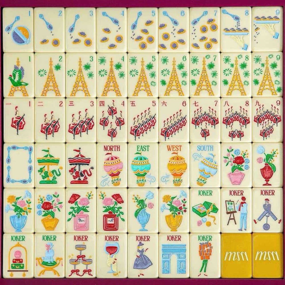 Yellow Paris Cafe Mahjong tiles with pale yellow faces, Eiffel Tower motifs, teacups, flower vases and illustrated Jokers